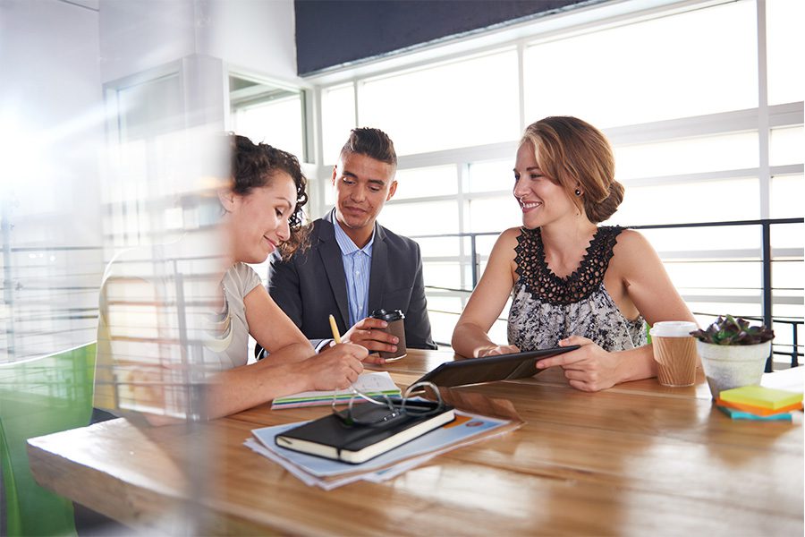 About Our Agency - Team of Business People Having a Meeting in Executive Sunlit Office